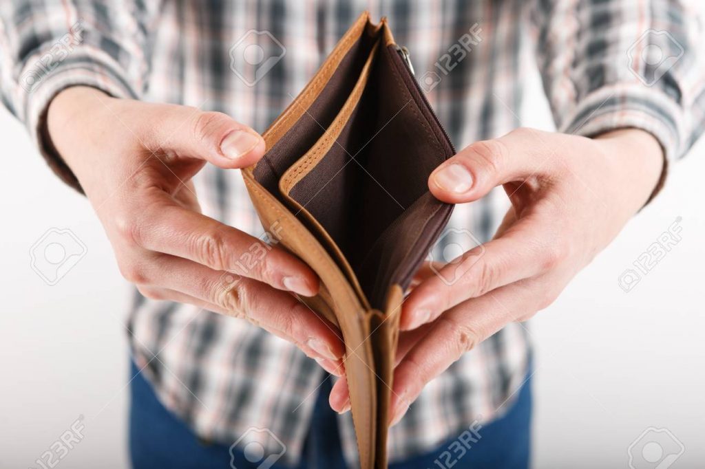 empty wallet in the hands of an elderly man poverty in retirement concept