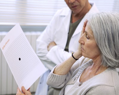 Woman Looking at Amsler Grid in Doctors Office