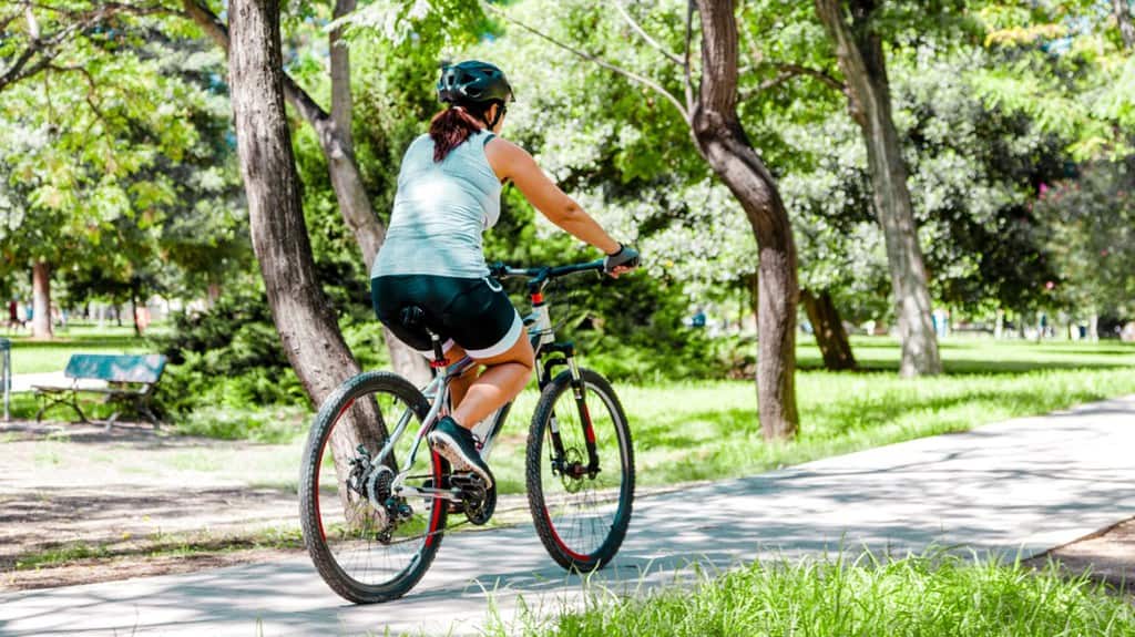 Woman riding bycicle at the park header