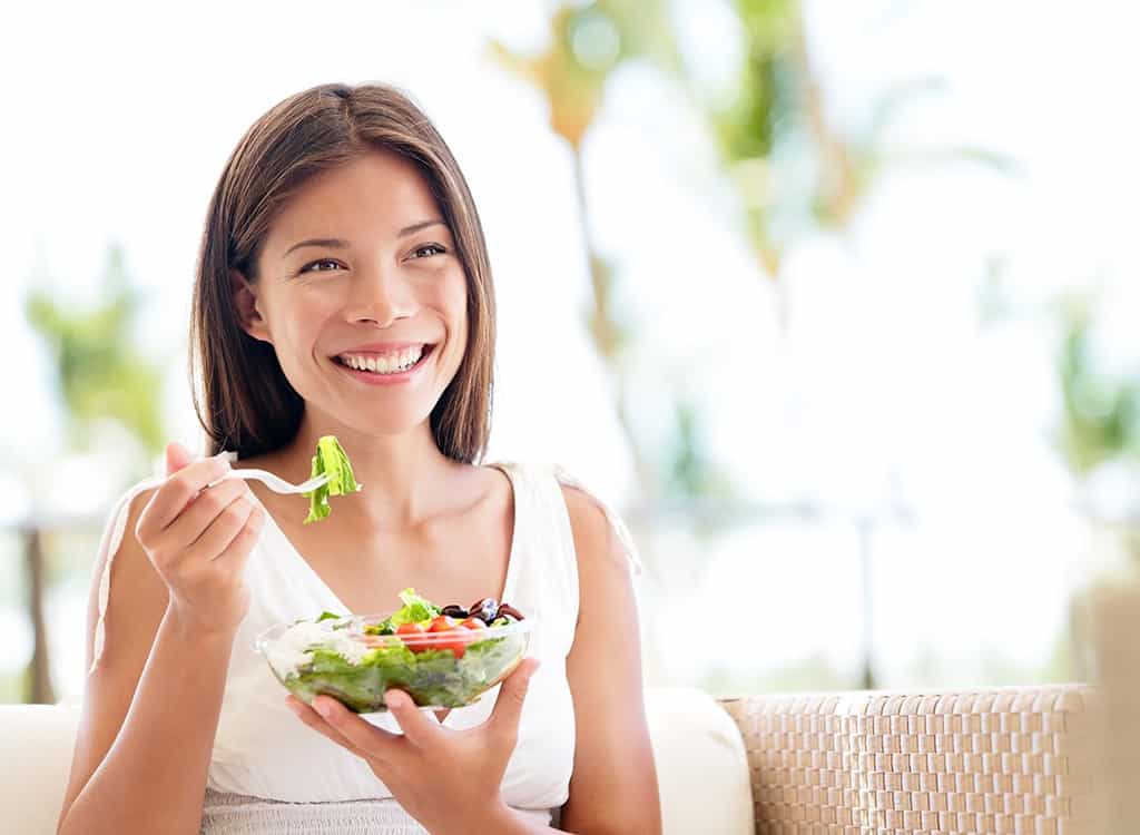 happy woman eating salad